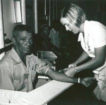 Martha Hopkins, Medical Technologist, drawing blood from a patient.